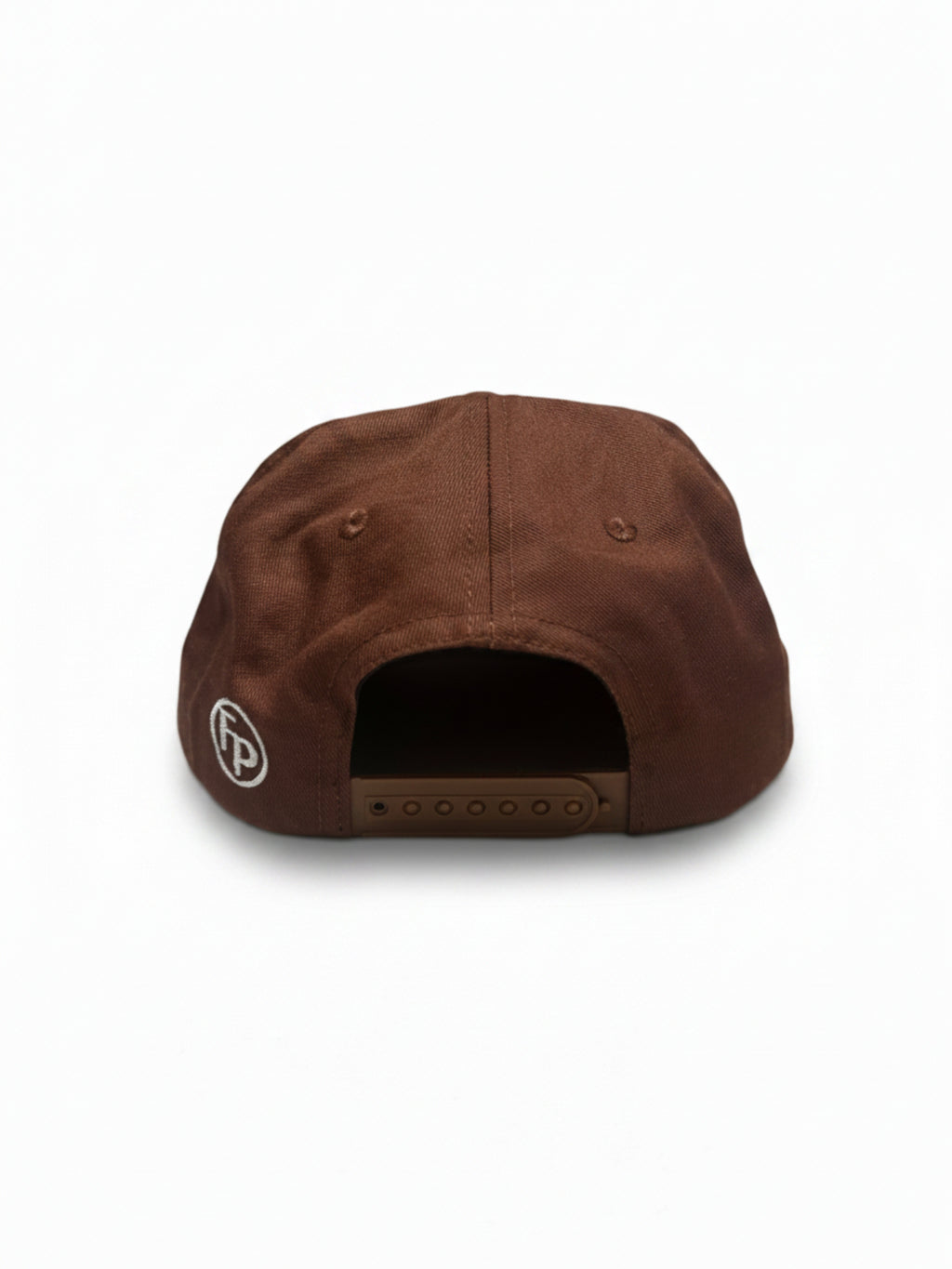 A brown snapback cap shown from the back, featuring a small circular white logo with 'FP' on the side and a brown adjustable strap closure.