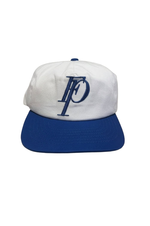 A white and royal blue baseball cap featuring an embroidered navy blue 'FP' logo on the front, set against a plain white background.